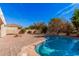 Inviting kidney-shaped pool with brick patio and landscaping at 2301 E Azalea Dr, Chandler, AZ 85286