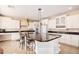 Island kitchen with granite countertops, white cabinets, and stainless steel appliances at 2301 E Azalea Dr, Chandler, AZ 85286