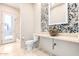 Bathroom with stone sink and pebble tile accent wall at 8170 E Golden Spur Ln, Carefree, AZ 85377