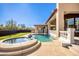 Resort-style pool and spa with a cascading waterfall and grassy area at 8170 E Golden Spur Ln, Carefree, AZ 85377