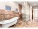 Spa-like bathroom with soaking tub and glass block shower at 8170 E Golden Spur Ln, Carefree, AZ 85377