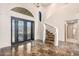 Grand entryway with marble floors and a curved staircase at 8170 E Golden Spur Ln, Carefree, AZ 85377