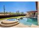 Inviting pool and spa with a waterfall feature, surrounded by lush landscaping at 8170 E Golden Spur Ln, Carefree, AZ 85377