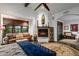 Main bedroom with fireplace and large windows offering abundant natural light at 36975 N Mirabel Club Dr, Scottsdale, AZ 85262