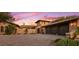 Three-car garage with stone and stucco exterior at 36975 N Mirabel Club Dr, Scottsdale, AZ 85262