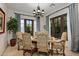 Bright dining room with large windows and rustic wooden table at 36975 N Mirabel Club Dr, Scottsdale, AZ 85262