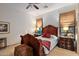 Serene bedroom with a wooden bed frame, two nightstands, and large windows at 36975 N Mirabel Club Dr, Scottsdale, AZ 85262