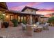 Stone patio with fire pit and comfortable seating at 36975 N Mirabel Club Dr, Scottsdale, AZ 85262