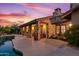 Luxury pool and patio area with outdoor seating and stunning sunset views at 36975 N Mirabel Club Dr, Scottsdale, AZ 85262