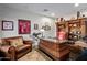 Home office with large desk, comfortable chair and built-in shelving at 36975 N Mirabel Club Dr, Scottsdale, AZ 85262