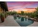 Inviting swimming pool with a waterfall feature and desert landscaping at 36975 N Mirabel Club Dr, Scottsdale, AZ 85262