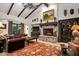 Open living room with a stone fireplace and high, beamed ceilings at 36975 N Mirabel Club Dr, Scottsdale, AZ 85262