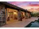 Covered patio with stone pillars and poolside access at 36975 N Mirabel Club Dr, Scottsdale, AZ 85262