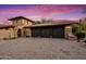 Three-car garage with dark brown doors at 36975 N Mirabel Club Dr, Scottsdale, AZ 85262