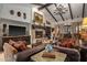 Living room with a stone fireplace, large TV, and comfortable seating at 36975 N Mirabel Club Dr, Scottsdale, AZ 85262