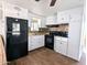 Bright kitchen features white cabinets, black appliances, and tile flooring at 7300 N 51St Ave # F93, Glendale, AZ 85301