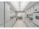 Kitchen with white cabinets, tiled floor, and appliances at 10101 W Desert Rock Dr, Sun City, AZ 85351