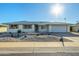 Ranch-style home with carport and rock landscaping at 10101 W Desert Rock Dr, Sun City, AZ 85351