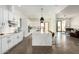 Modern kitchen with white cabinets, large island, and stainless steel appliances at 23008 E Galveston St, Mesa, AZ 85212