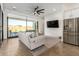 Gathering room with grey sofa and sliding glass doors at 23008 E Galveston St, Mesa, AZ 85212