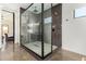 Modern shower with glass enclosure and geometric tile floor at 23008 E Galveston St, Mesa, AZ 85212