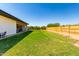 Expansive backyard with grassy lawn and wooden fence at 23008 E Galveston St, Mesa, AZ 85212