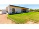 Backyard view of home showcasing covered patio and grassy area at 23008 E Galveston St, Mesa, AZ 85212