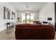 Bright living room, featuring a leather sofa and access to the backyard at 23008 E Galveston St, Mesa, AZ 85212