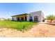 Back view of modern home with covered patio and grassy yard at 23008 E Galveston St, Mesa, AZ 85212