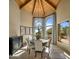 Elegant dining room with a wood ceiling, large windows, and a rustic chandelier at 8530 E Via Montoya --, Scottsdale, AZ 85255