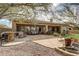 Landscaped backyard oasis with a stone patio, built-in BBQ, and fountain at 3660 S Golden Eye Ln, Gold Canyon, AZ 85118