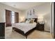 Relaxing bedroom with dark wood bed frame and neutral bedding at 3660 S Golden Eye Ln, Gold Canyon, AZ 85118