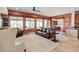Living room with a ceiling fan, large windows, and brown leather sofas at 3660 S Golden Eye Ln, Gold Canyon, AZ 85118