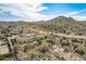 Aerial view of a luxury home nestled in a desert mountain setting at 3660 S Golden Eye Ln, Gold Canyon, AZ 85118