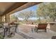 Spacious backyard patio with flagstone, seating area, and lovely desert landscaping at 3660 S Golden Eye Ln, Gold Canyon, AZ 85118