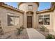 Front entry with a courtyard, decorative plants, and a security door at 3660 S Golden Eye Ln, Gold Canyon, AZ 85118