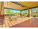 Community patio with tables, chairs, and grills under a pergola at 3660 S Golden Eye Ln, Gold Canyon, AZ 85118