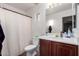 Clean bathroom with wood vanity, shower/tub combo, and a large mirror at 2529 W Florentine Rd, Phoenix, AZ 85086