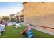 Landscaped backyard with artificial turf, playground, and seating at 2529 W Florentine Rd, Phoenix, AZ 85086