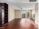 Bright living room with dark wood floors and a view to the patio at 1601 W Sunnyside Dr # 154, Phoenix, AZ 85029