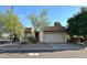 Tan colored stucco home with a white garage door and mature landscaping at 7006 E Jensen St # 83, Mesa, AZ 85207