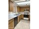 Kitchen with wood cabinets, tile floor, and white appliances at 7006 E Jensen St # 83, Mesa, AZ 85207