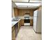 Kitchen features wood cabinets, tile floors, and a white stove at 7006 E Jensen St # 83, Mesa, AZ 85207