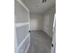Spacious bedroom with gray tile floors and a frosted glass door at 38422 W Buckeye Rd, Tonopah, AZ 85354