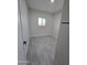 Simple bedroom with gray tile floor and a window at 38422 W Buckeye Rd, Tonopah, AZ 85354