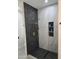 Modern shower with hexagon tile, built-in shelves, and rainfall shower head at 38422 W Buckeye Rd, Tonopah, AZ 85354