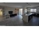 Open concept kitchen with island, modern appliances, and gray tile floors at 38422 W Buckeye Rd, Tonopah, AZ 85354