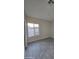 Bright bedroom featuring gray tile floors and large window at 38422 W Buckeye Rd, Tonopah, AZ 85354