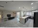 Open concept kitchen with island, modern appliances, and gray tile floors at 38422 W Buckeye Rd, Tonopah, AZ 85354