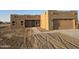 Newly constructed home with stucco exterior, attached garage, and walkway at 38422 W Buckeye Rd, Tonopah, AZ 85354